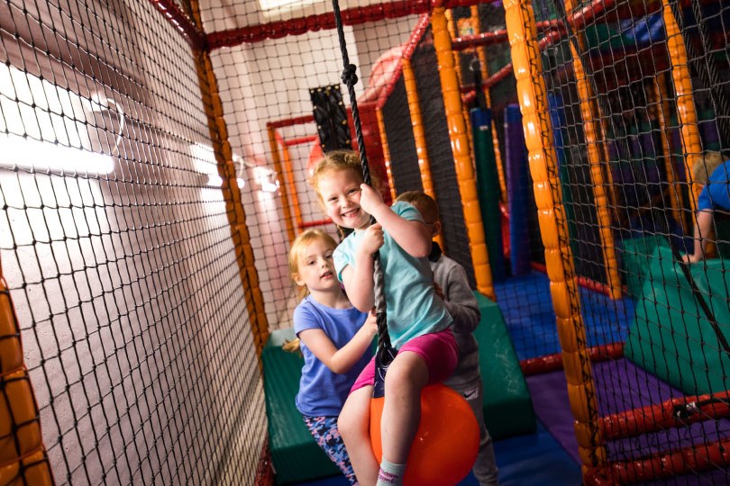 Girl Swinging on the Swinging Ball at Airtastic Soft Play Centre in Newtownabbey