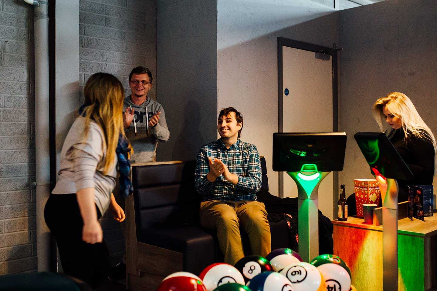 Two Couples sitting at an Airtastic Bowling Lane