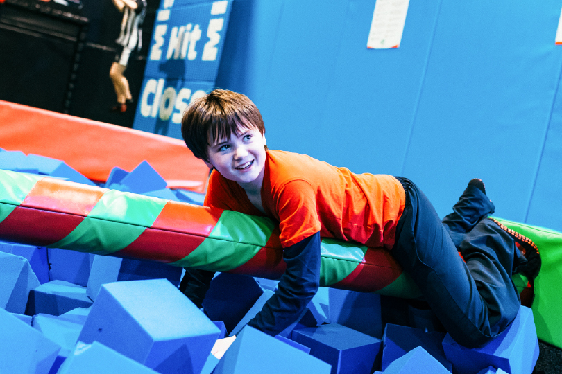 Boy Holds onto Spinning Pole at Airtastic Ninja Park